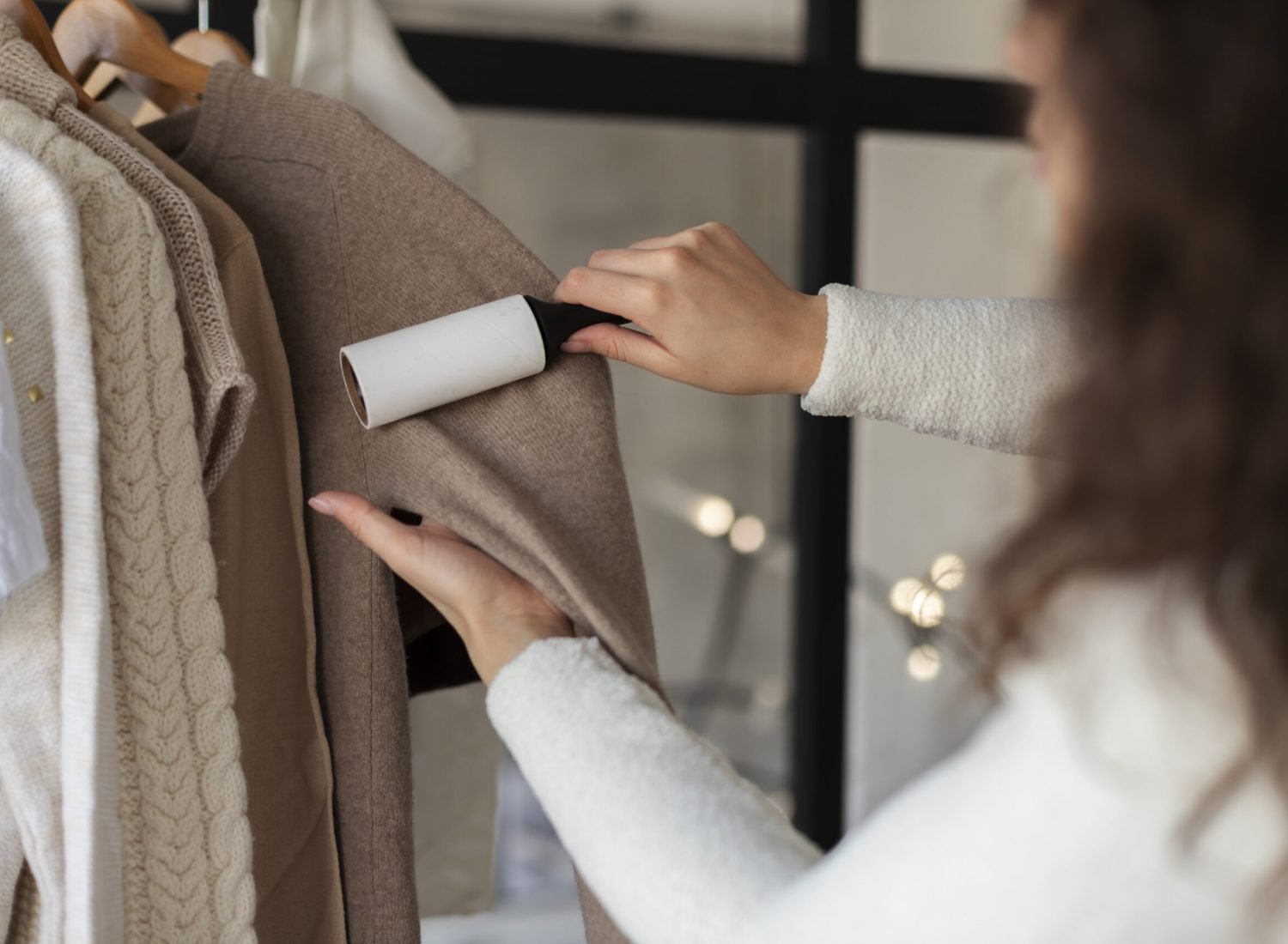 close-up-woman-using-lint-roller